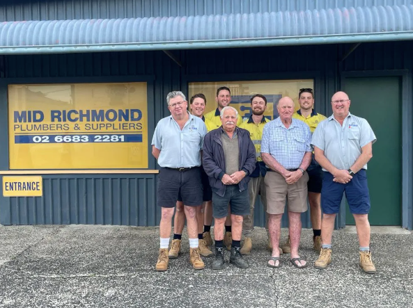 A Group of Men Standing in Front of a Building — Mid Richmond Plumbers & Suppliers in Coraki, NSW