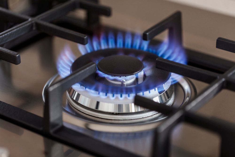 A Close Up of a Gas Stove With Flames Coming Out of It — Mid Richmond Plumbers & Suppliers in Coraki, NSW