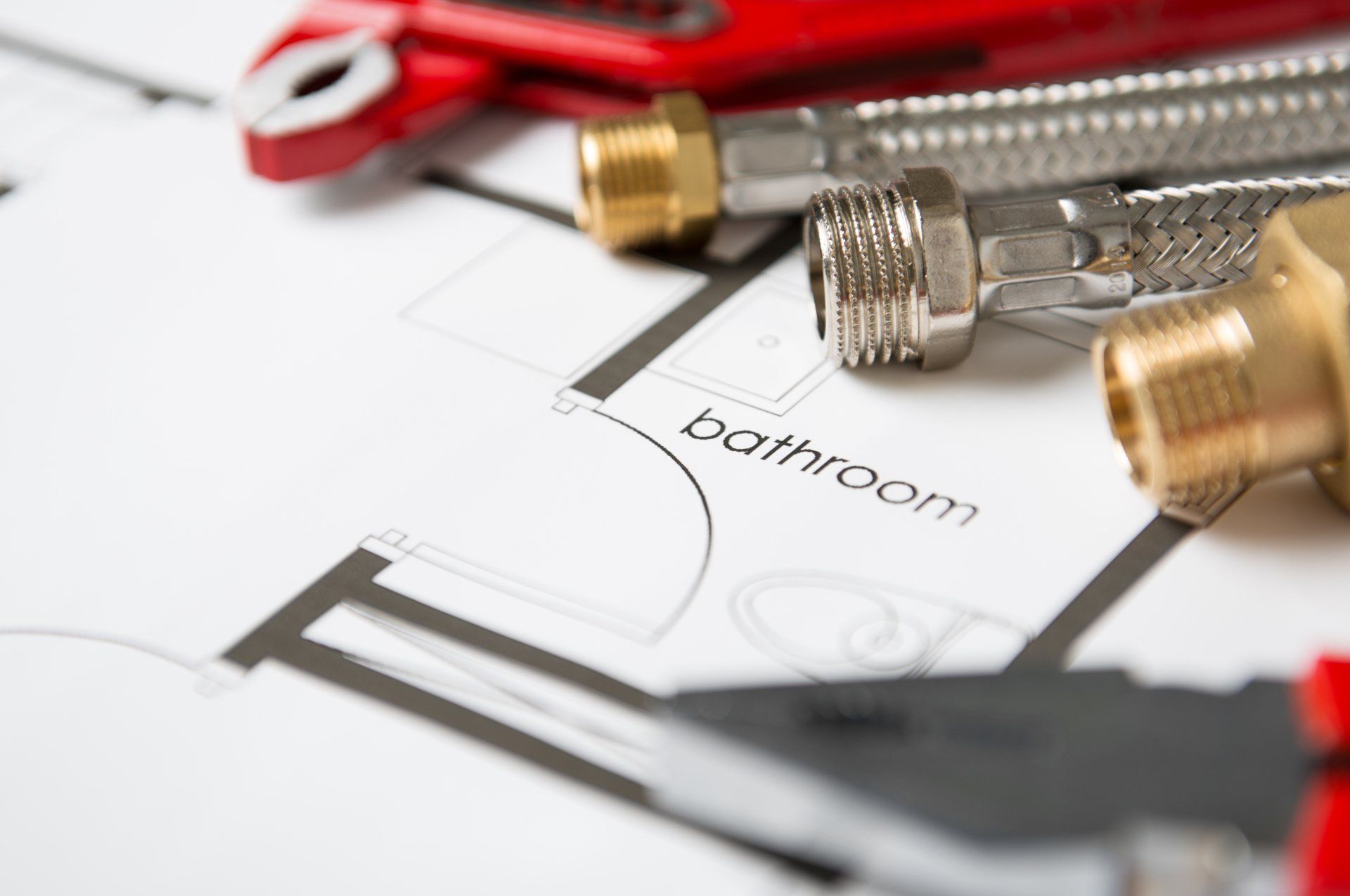 plumbers tools sitting on desk with plans