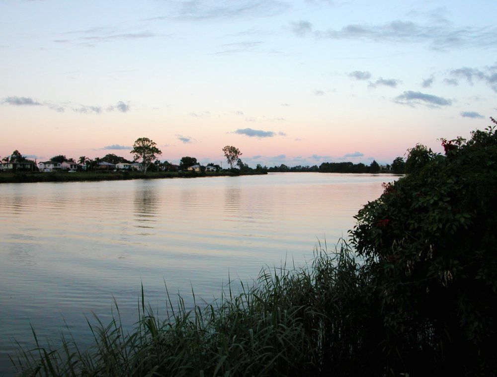 A Large Body of Water with A Sunset in The Background — Mid Richmond Plumbers & Suppliers in Coraki, NSW