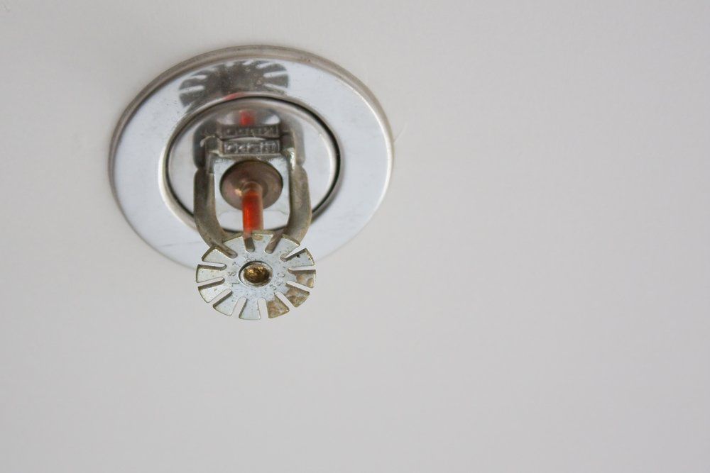 A Fire Sprinkler is Hanging From the Ceiling on a White Wall — Mid Richmond Plumbers & Suppliers in Coraki, NSW