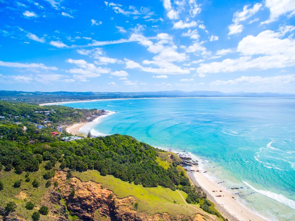 An Aerial View of A Beach and Ocean on A Sunny Day — Mid Richmond Plumbers & Suppliers in Byron Bay, NSW