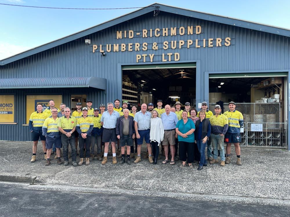 Group Photo in Front of Mid-richmond Plumbers & Suppliers Building — Mid Richmond Plumbers & Suppliers in Coraki, NSW