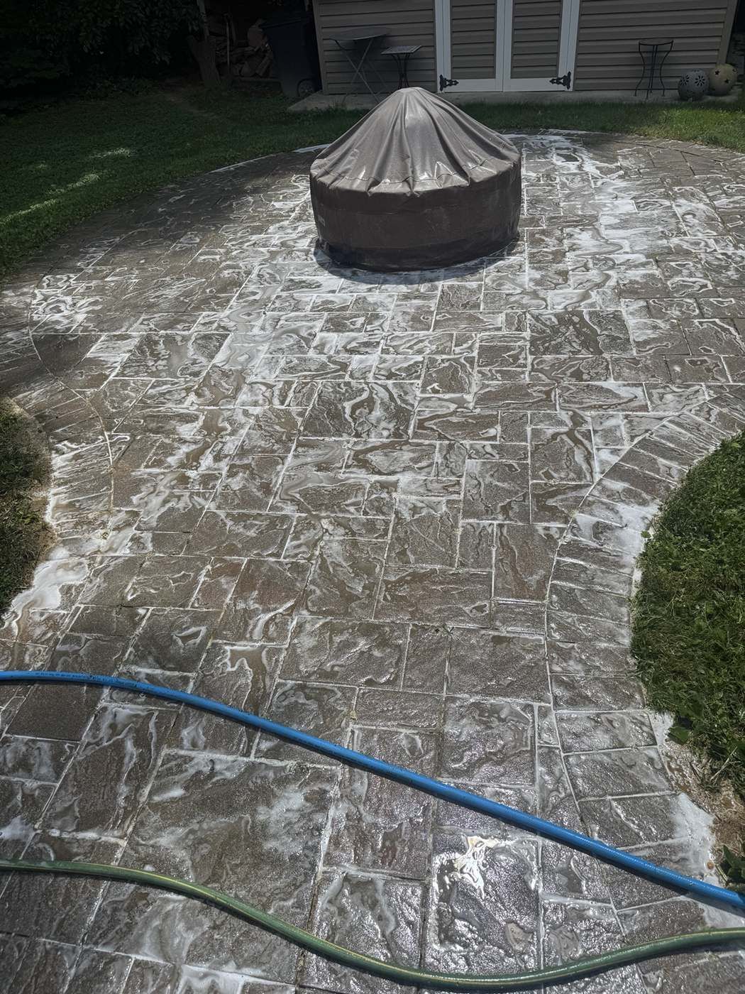 Paver patio during cleaning with foam solution