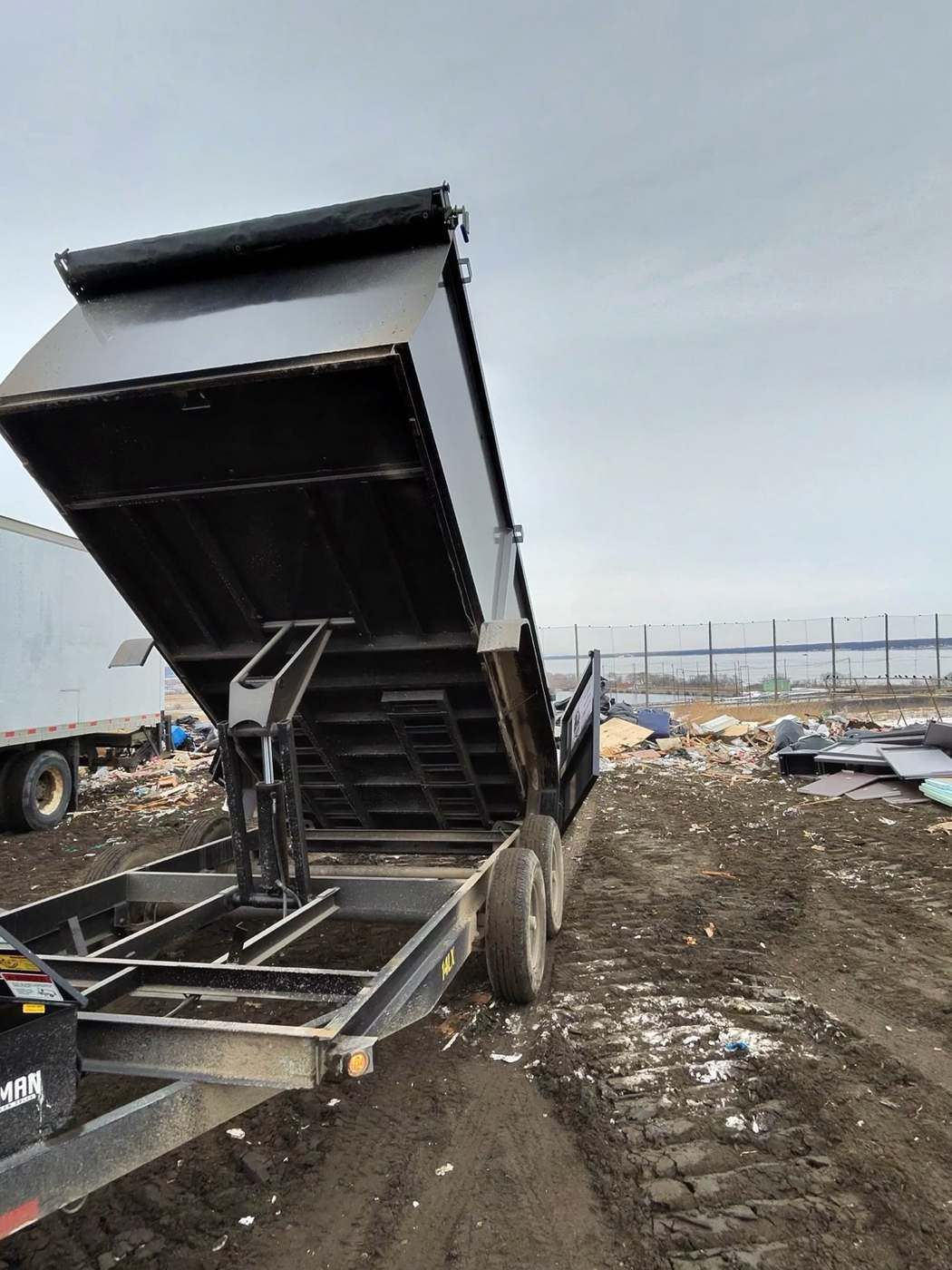 Trailer dumping load at disposal site