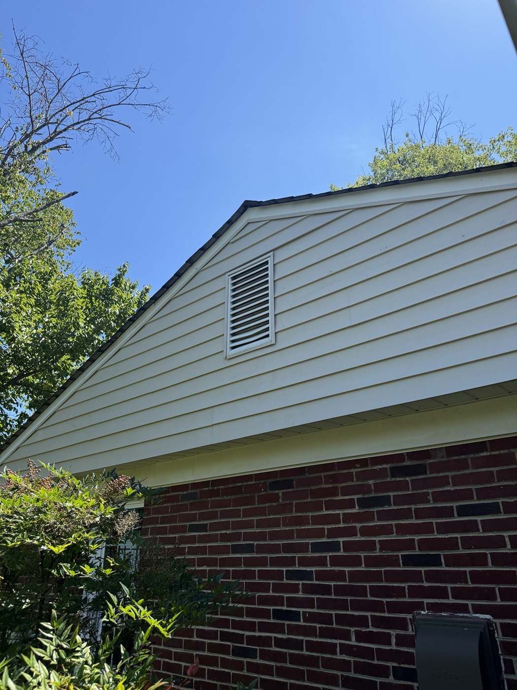 House siding and gable clean and restored after soft washing