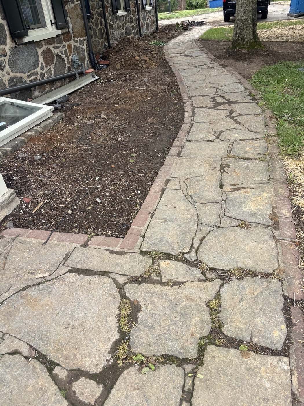 Stained stone walkway before pressure washing