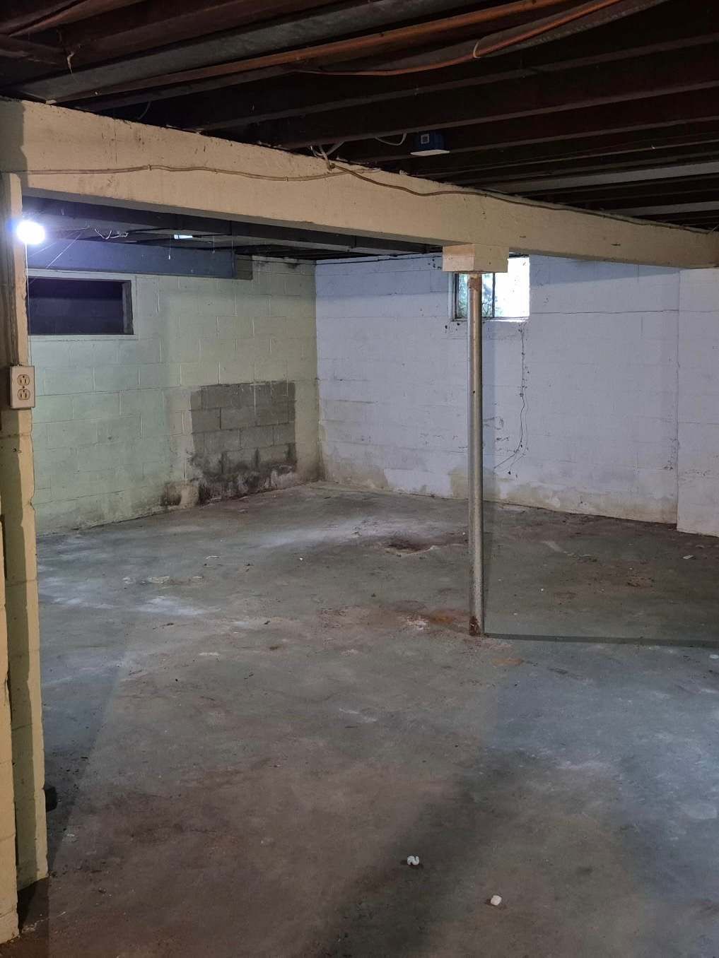 Cleared out basement with empty concrete floor after cleanout