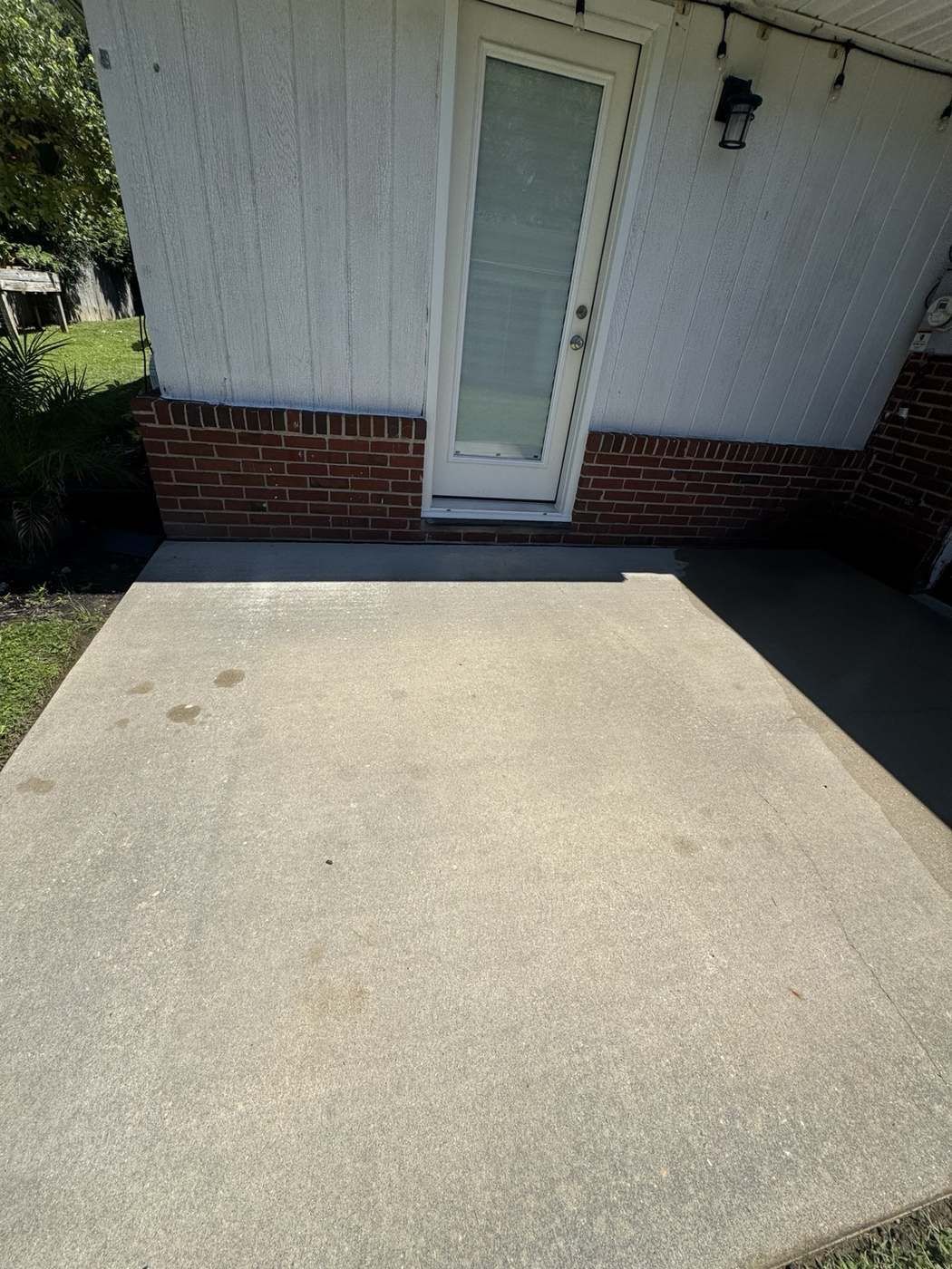 Clean concrete patio slab after pressure washing