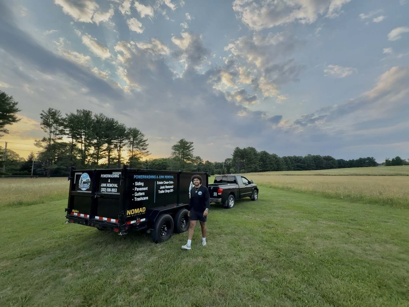 Owner Kody Edwards standing beside the branded 302 Property Services dump trailer and truck