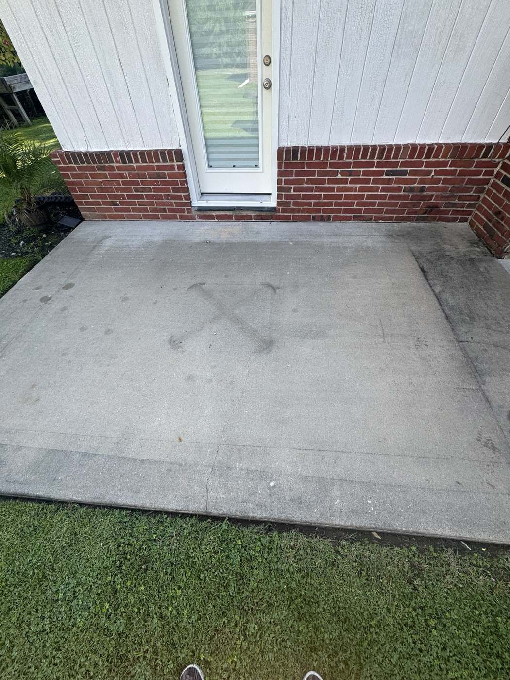 Concrete patio slab before pressure washing