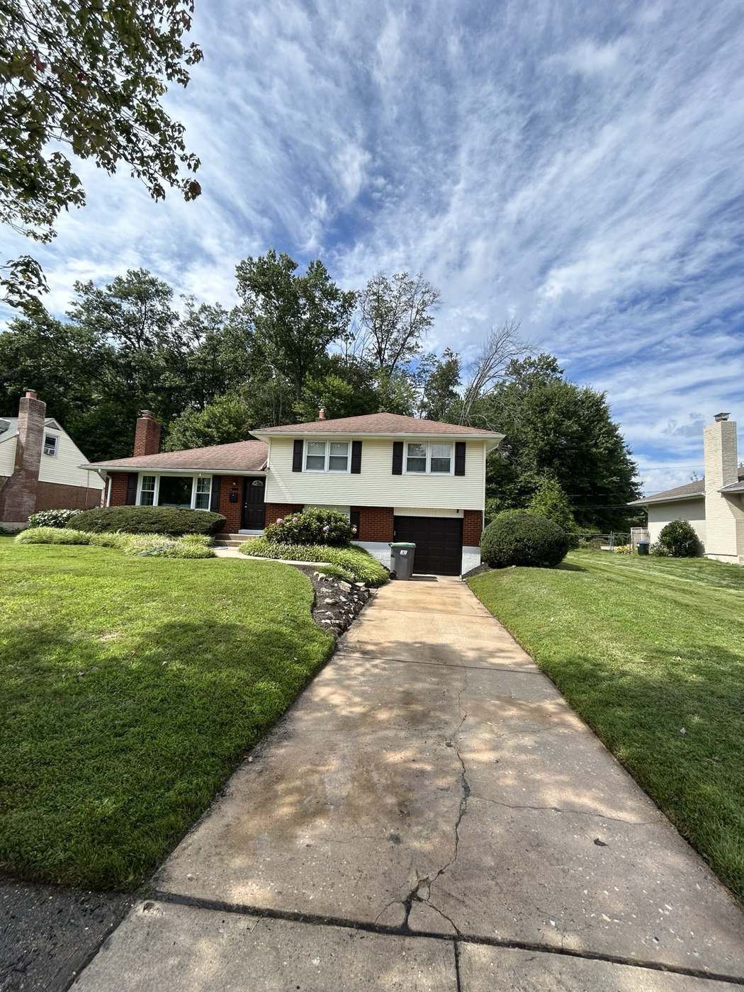 Clean driveway and walkway leading up to a two story home after pressure washing