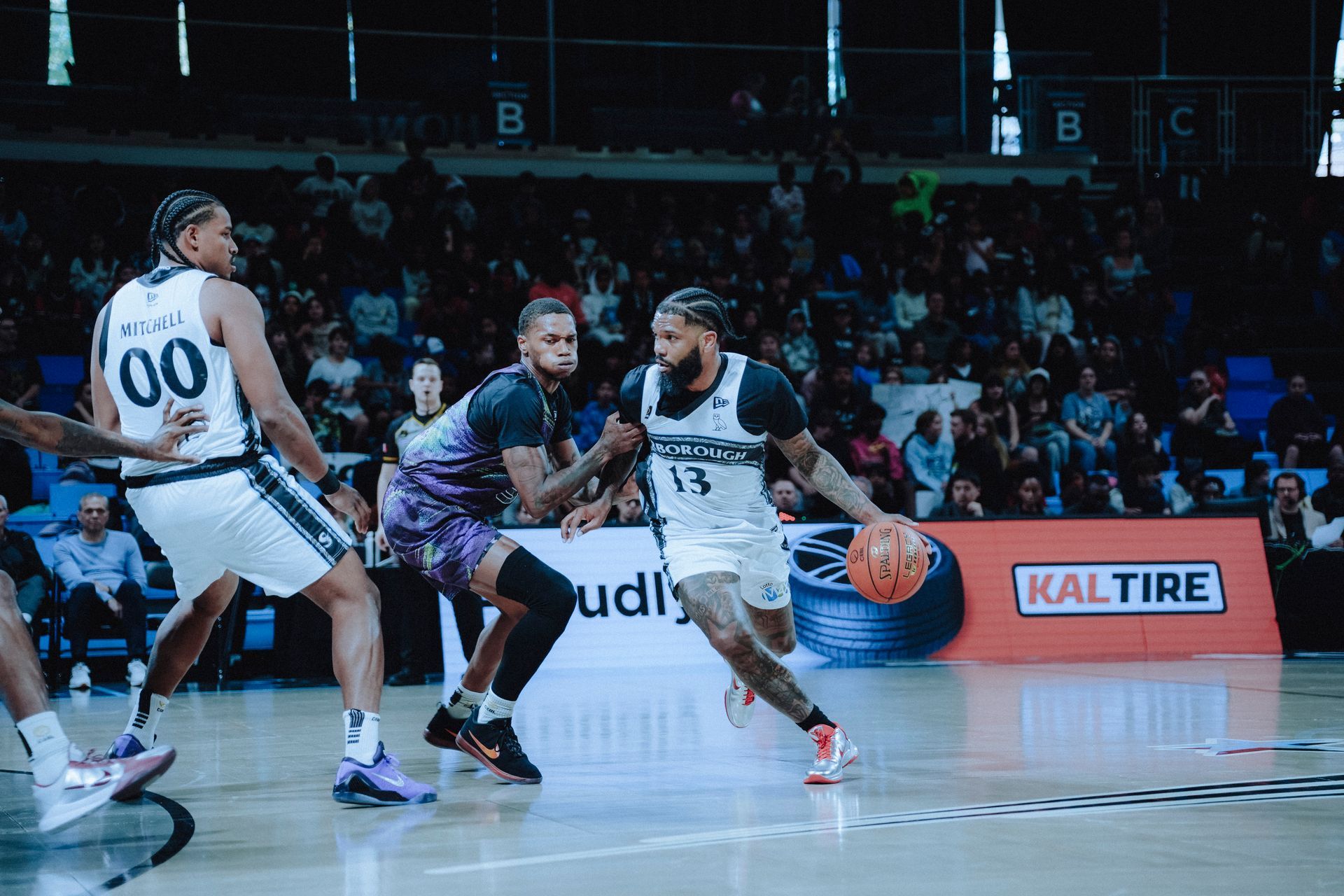 Myles Powell dribbling over a screen set by Frank Mitchell