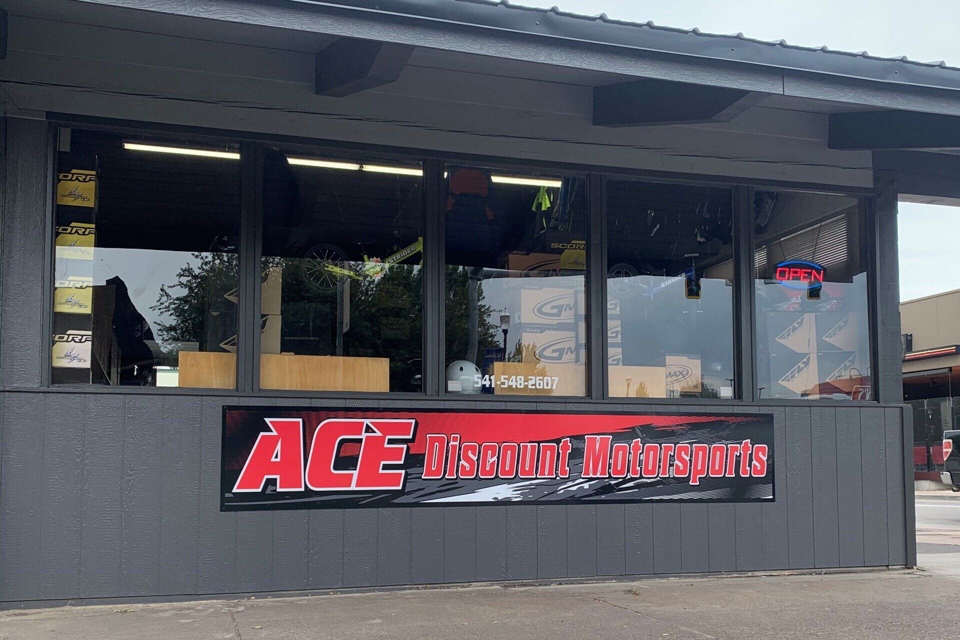A building with a sign that says ace discount motorsports
