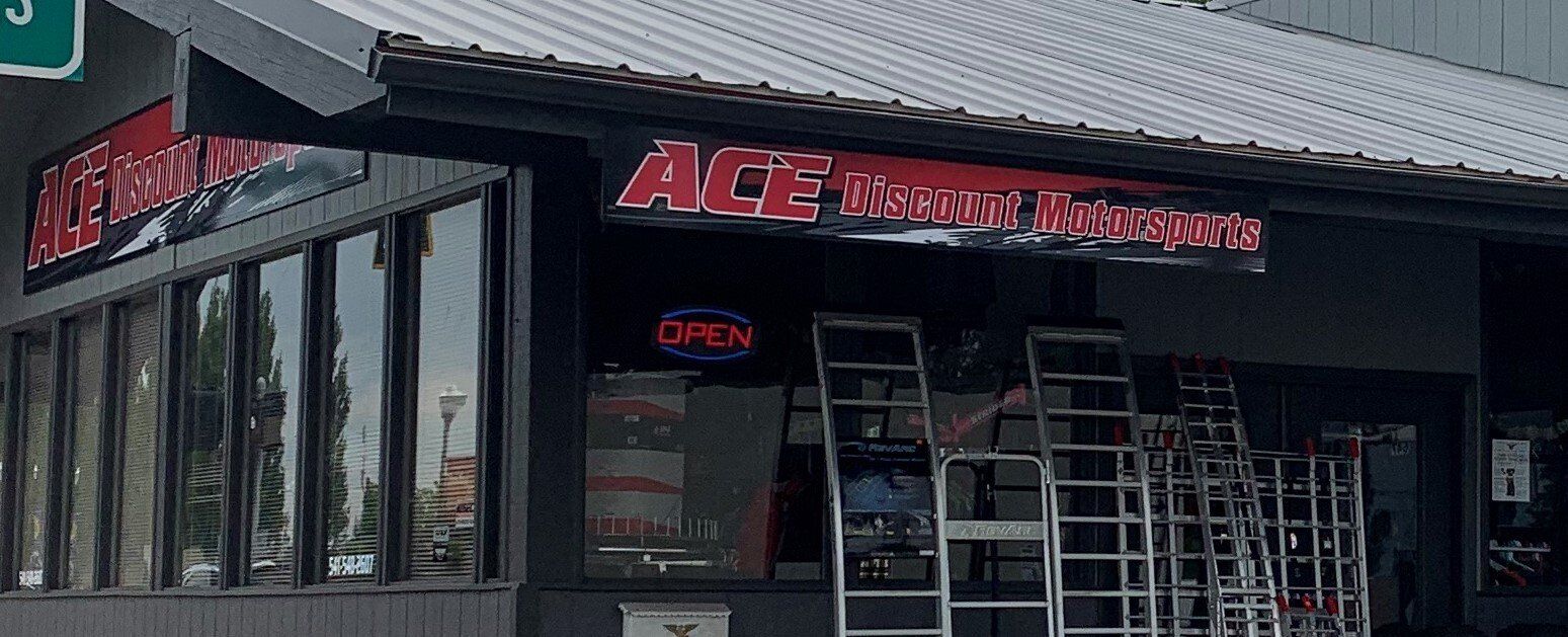 A store front with a neon sign that says open
