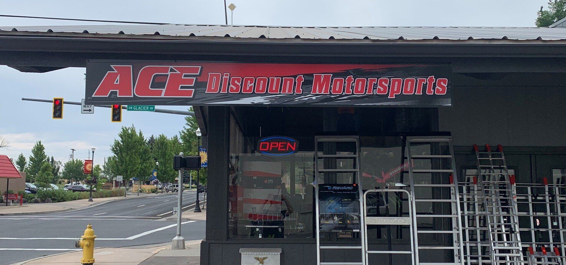 A store front with a sign that says ace recovery motorcycle parts