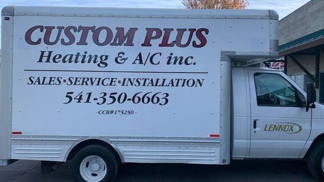 A white truck for custom plus heating and a/c inc.