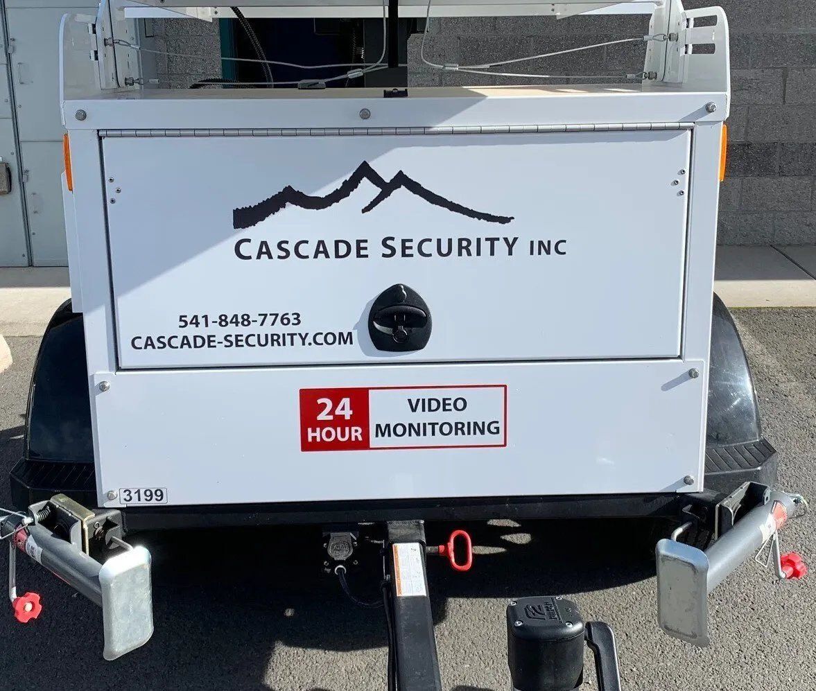 A trailer for cascade security inc is parked in a parking lot