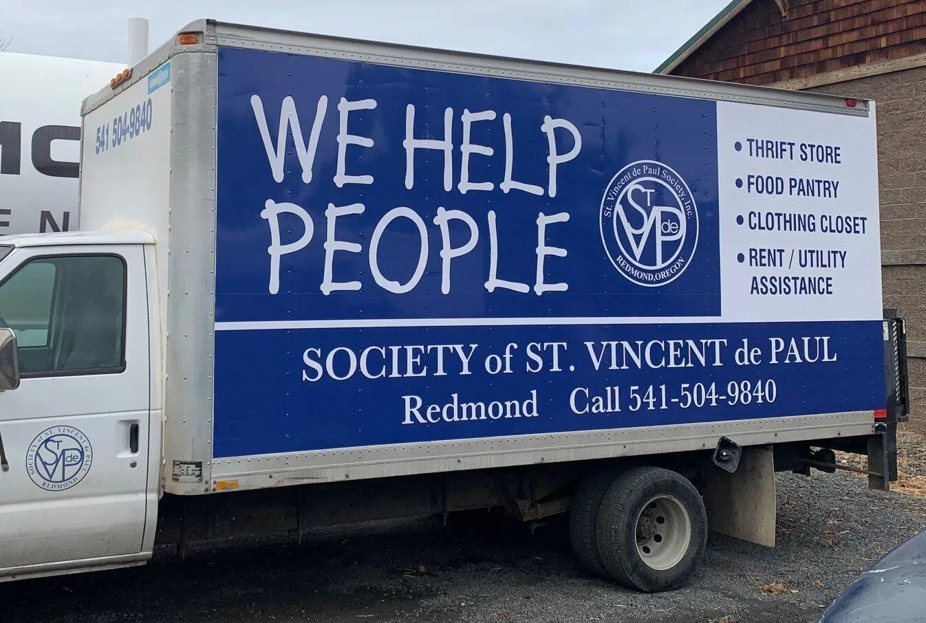 A truck that says we help people on the side