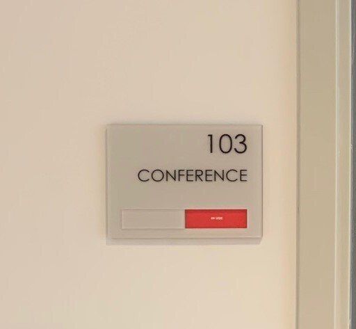 A sign on a door that says 103 conference