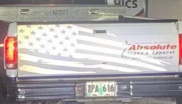 The back of a truck with an american flag on it.
