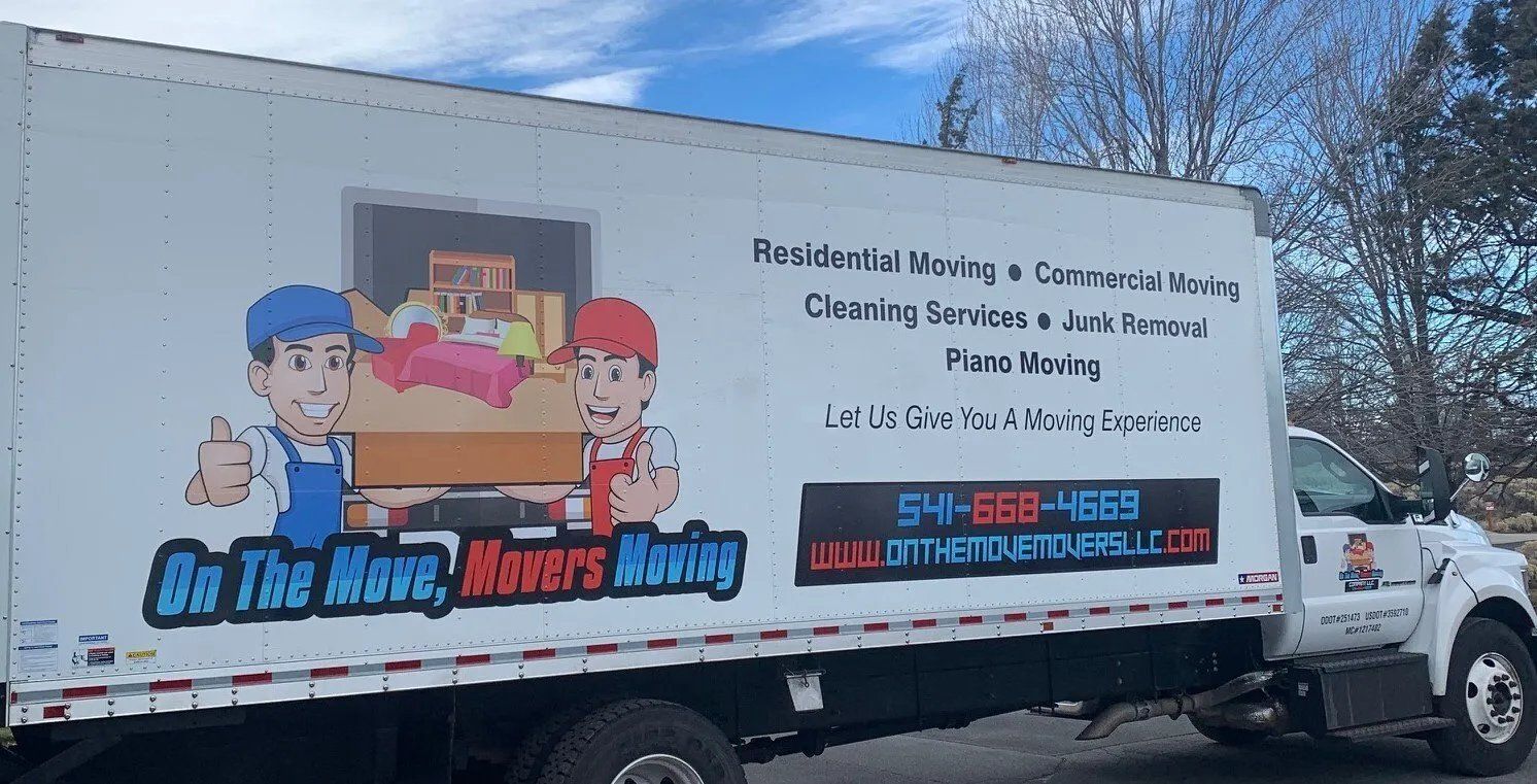A moving truck is parked on the side of the road.