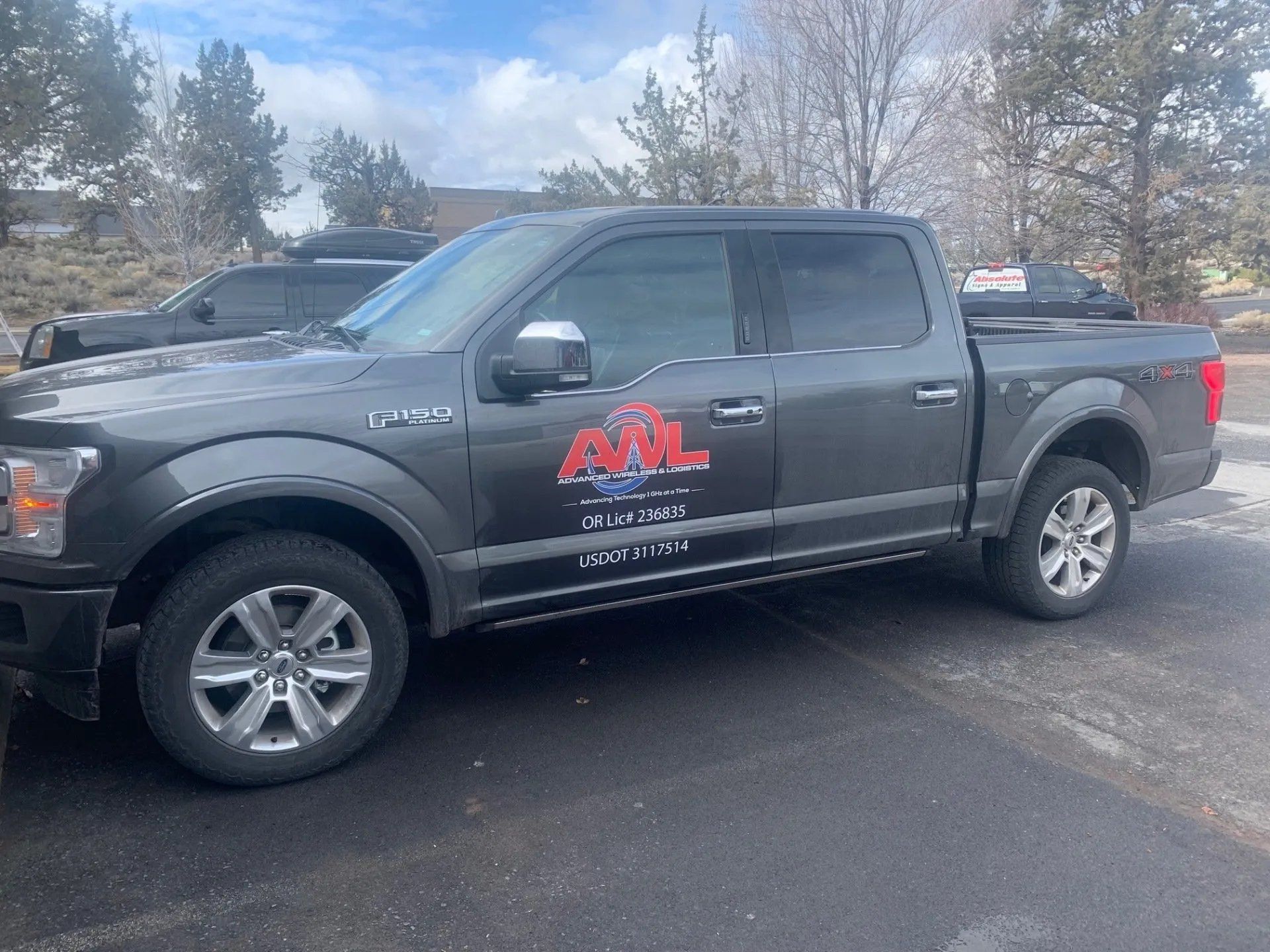 A black pickup truck is parked in a parking lot.