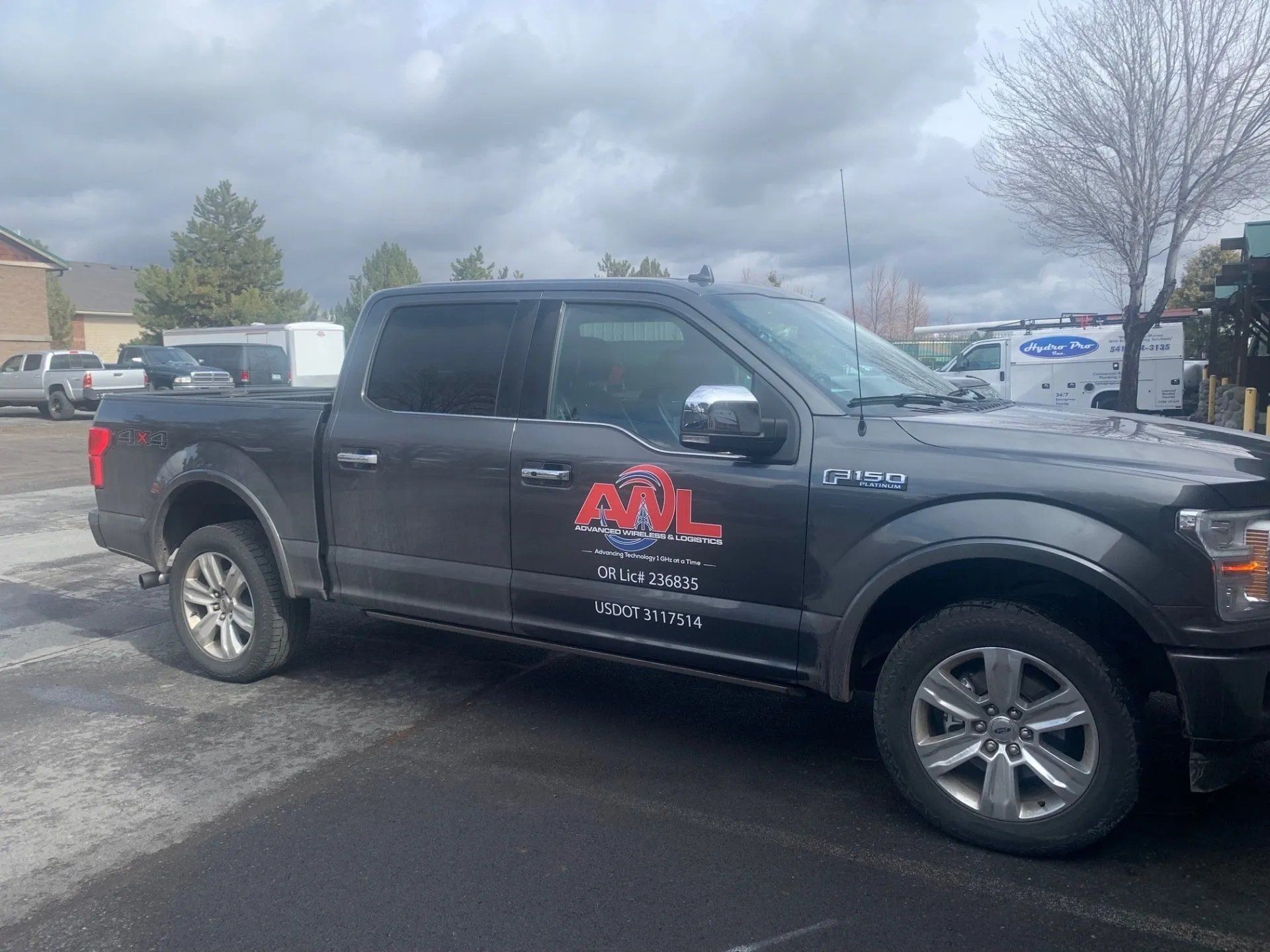 A black pickup truck is parked in a parking lot.