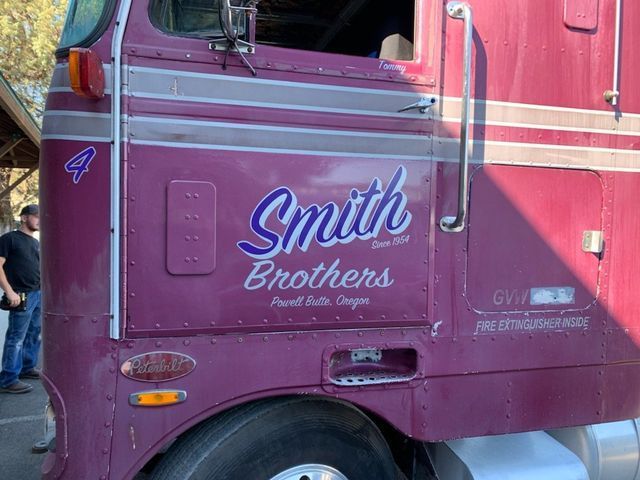 A purple semi truck with the word smith brothers on the side