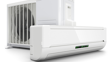 White air conditioner unit mounted on a ceiling above vertical blinds.