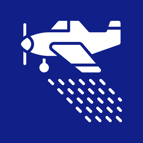 a small propeller plane is spraying water on a blue background .