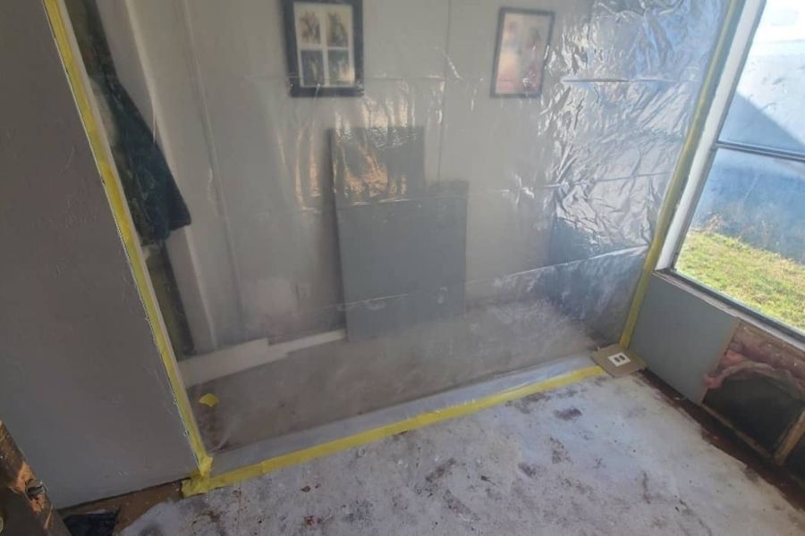 Plastic containment barriers set up during a professional water damage restoration project