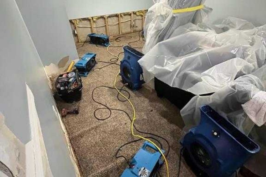 Professional drying equipment and air movers set up in a home during the water damage restoration process
