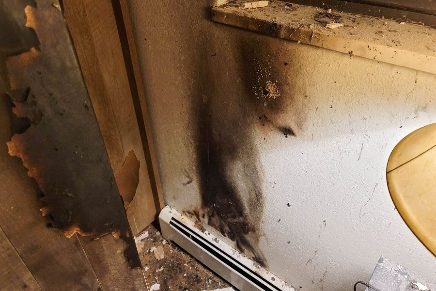 Drywall absorbing and trapping smoke damage particles after a house fire