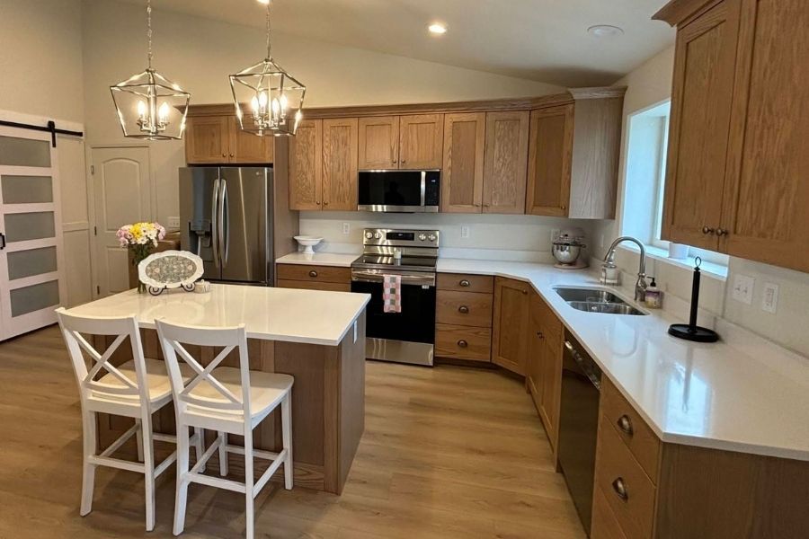 A kitchen fully rebuilt after fire damage with new cabinets and finishes