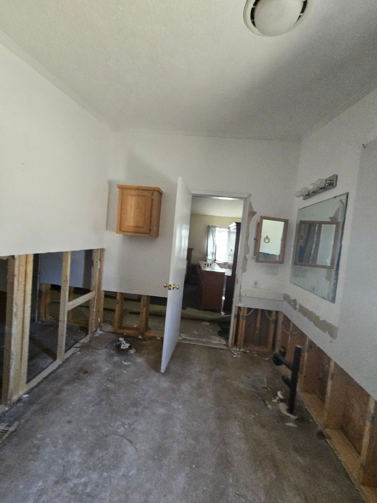 Kitchen water damage showing warped cabinets before reconstruction