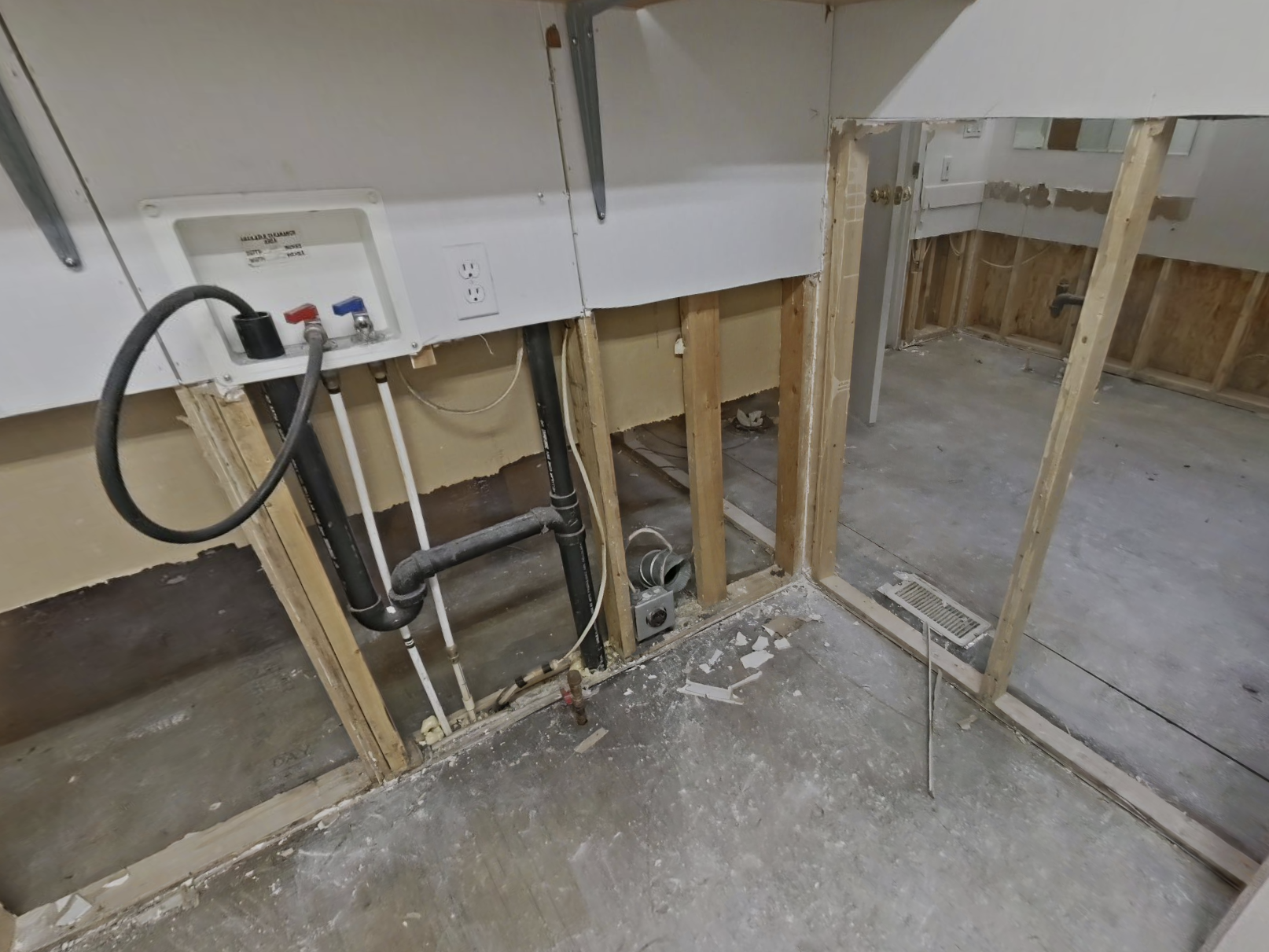 Laundry room with flood cuts and exposed walls