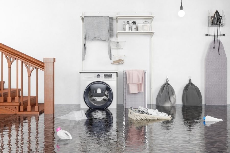 Laundry room with water damage from washing machine leak