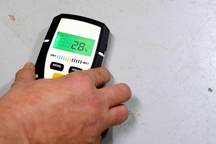 Professional moisture meter used during mold inspection to detect hidden moisture in walls