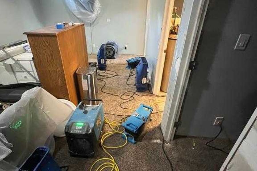 Professional water damage mitigation equipment set up inside a home during active drying