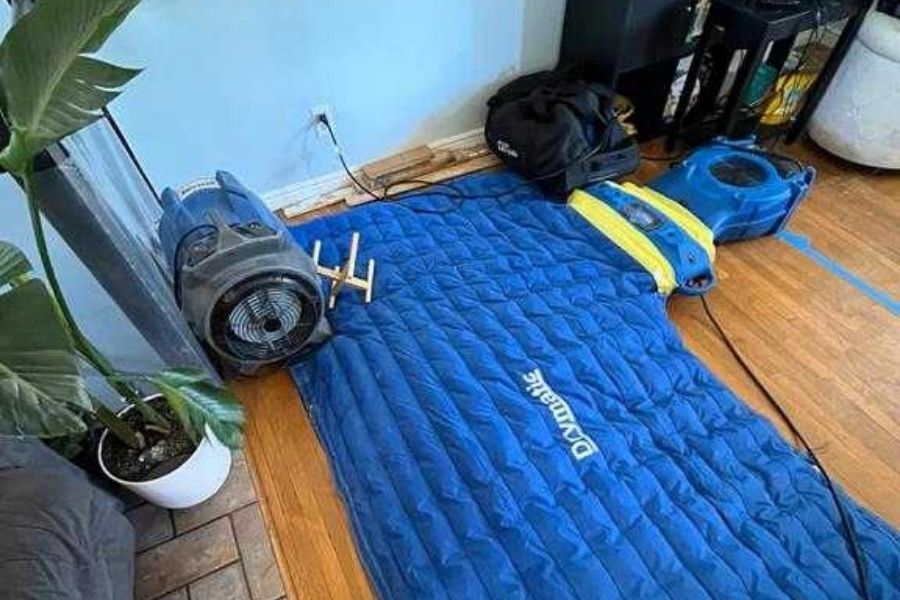 HEPA air scrubbers running during water damage mitigation to filter mold spores and contaminants from indoor air