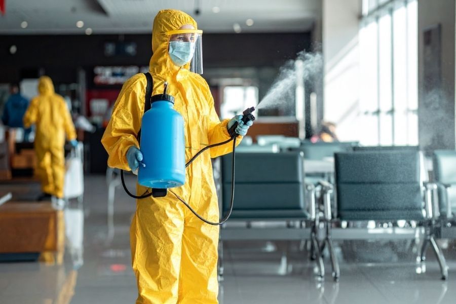 Restoration technician wearing full personal protective equipment during hazardous material assessment