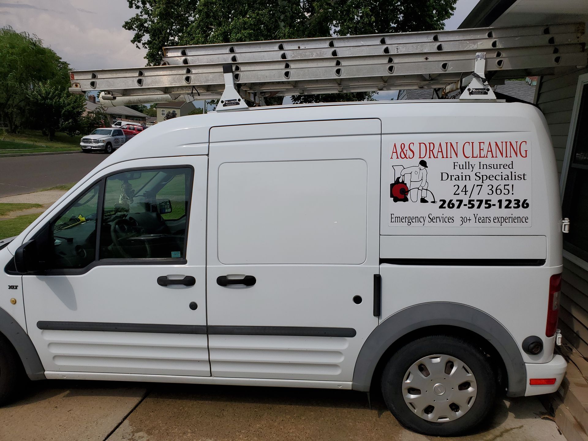 White service van with ladder on top, 