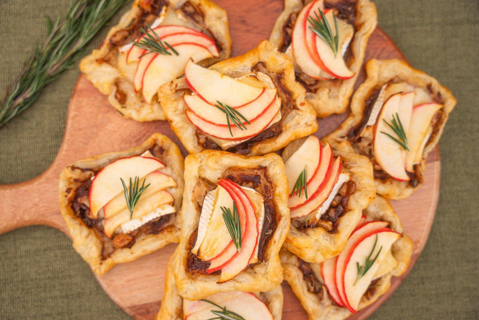 Wine and charcuterie spread at sunset with “Tasty Tuesday” event text