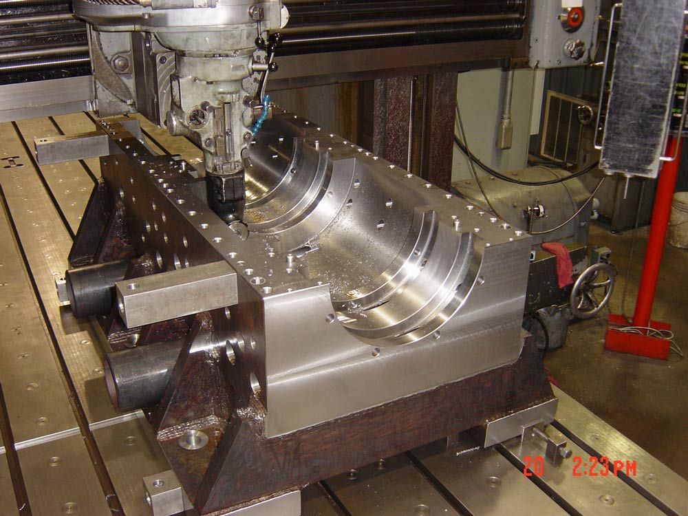 CNC milling machine machining a shiny metal part in a workshop