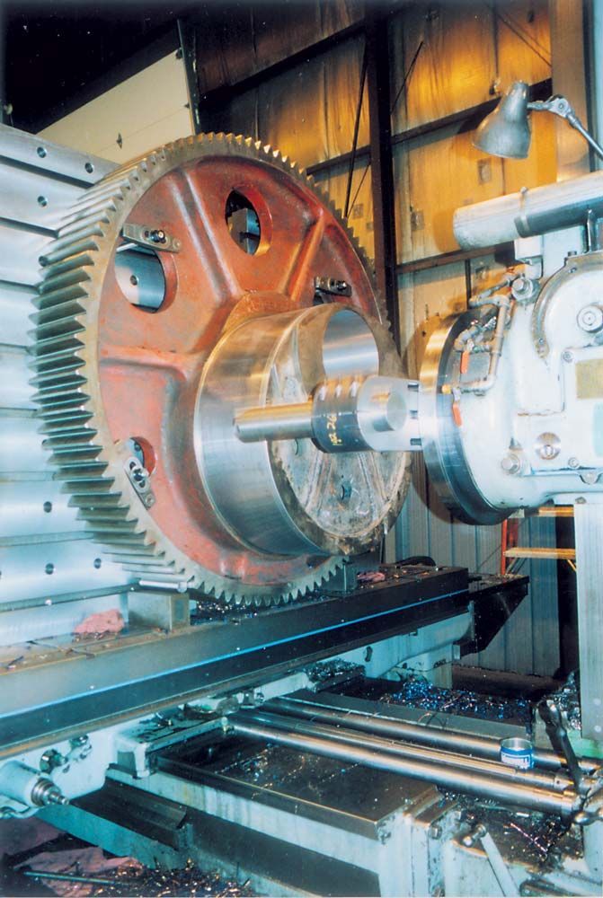 Industrial machine with a large copper gear and metal components in a workshop