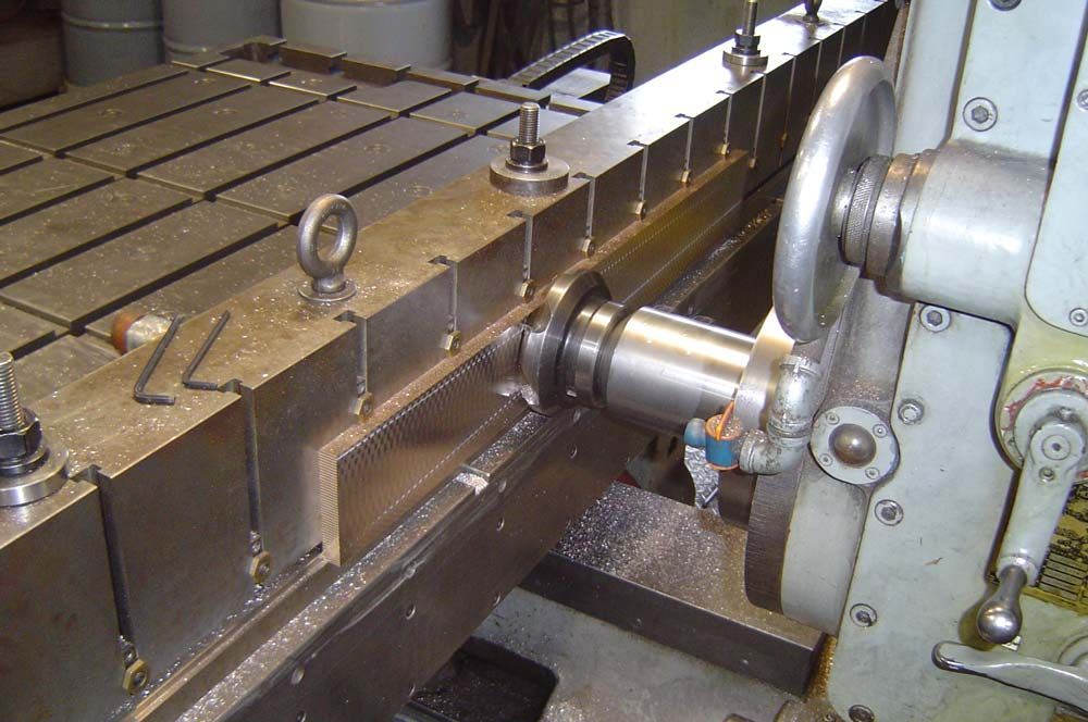 Metal lathe machining a cylindrical part with a rotating tool on a worktable