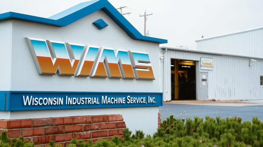 WIMS Wisconsin Industrial Machine Service, Inc. building sign on a white industrial facility