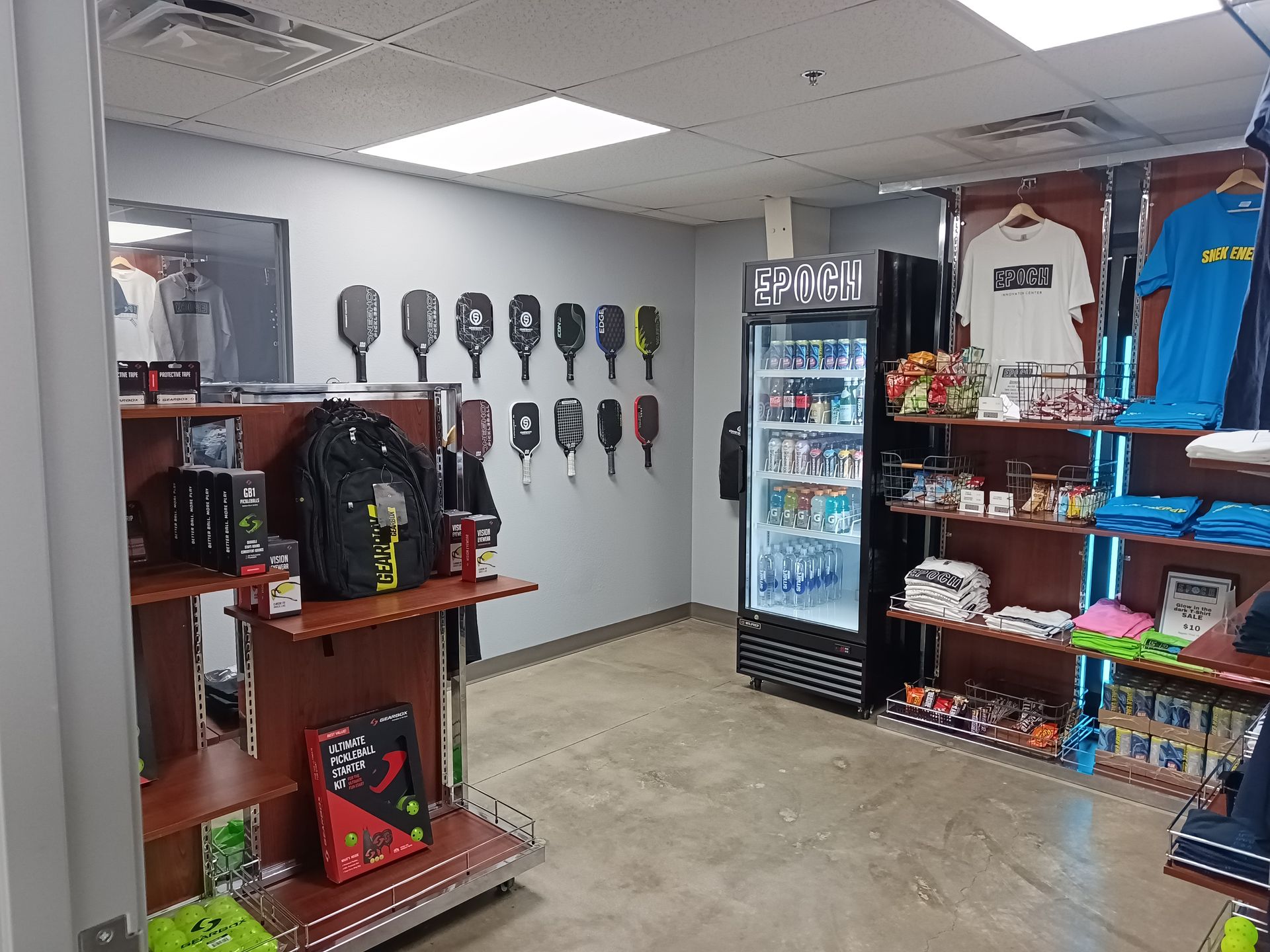 Small convenience store interior with snacks, drinks, and accessories on shelves