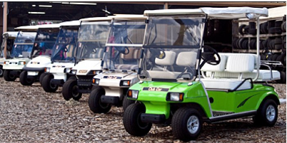 A row of golf carts parked next to each other